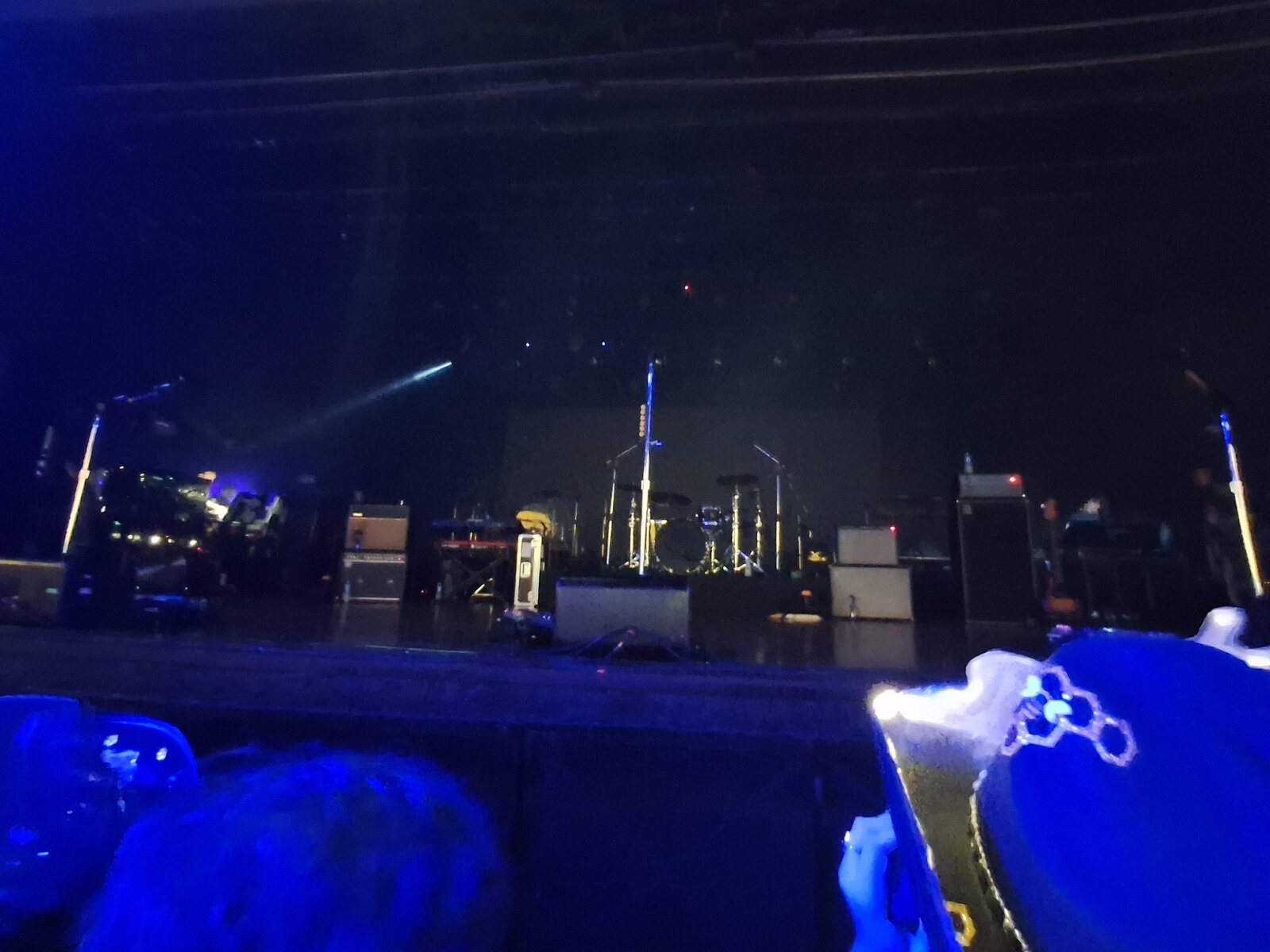 Dimly lit stage setup in a small club before or between live sets