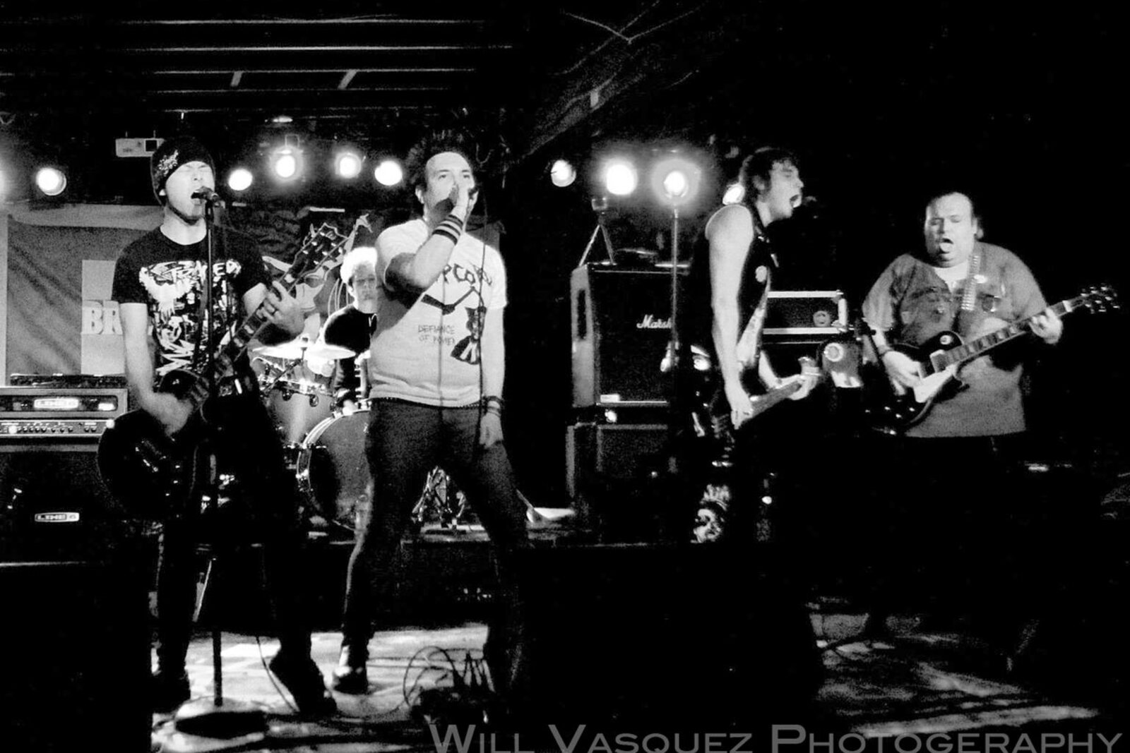 Sewer Anthem crowd-side stage photo with dramatic club lighting